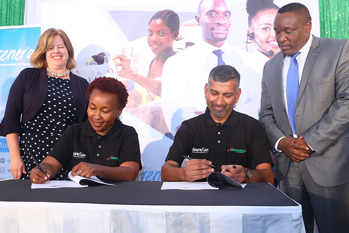 Safaricom Foundation’s Sylvia Mwangi and Generation Kenya’s Ramakrishnan Hariharan sign the partnership agreement as USAID’s Heather Schildge and the Principal Secretary in the State Department of Post Training and Skills Development, Mr. Alfred Cheruiyot, look on